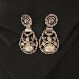 SILVER METAL PIERCED DROP EARINGS WITH RHINESTONE, BLACK, AND WHITE.